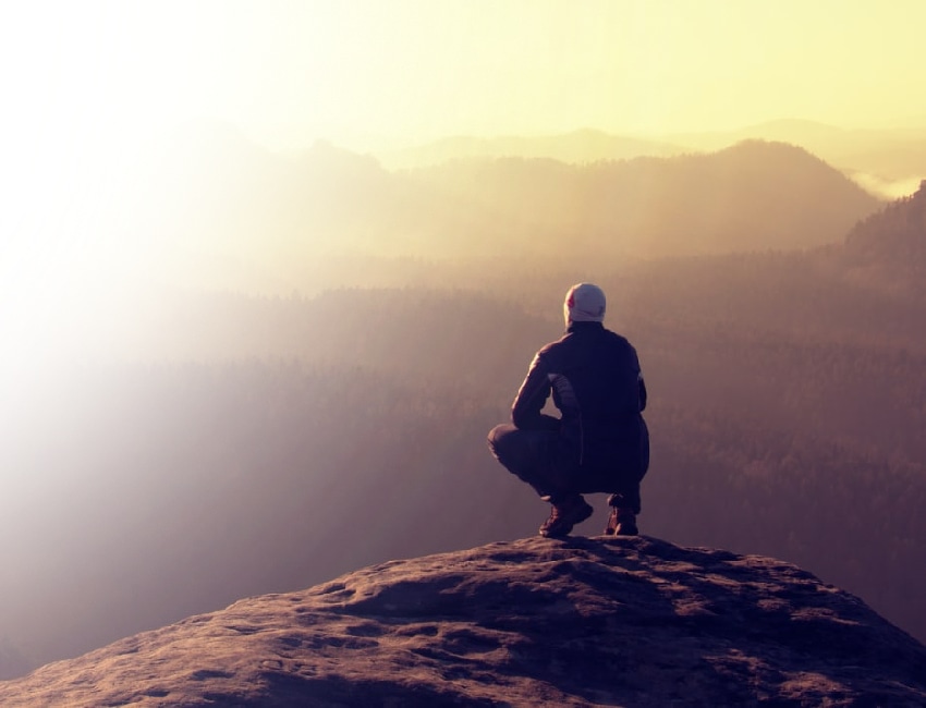 Man overlooking a valley, representing the journey of healing from PTSD and trauma in our Addiction Treatment program.