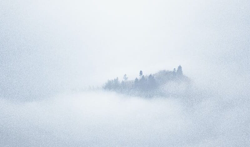 A person walking in a misty fog, symbolizing the surreal experience of nodding off under the influence of substances.