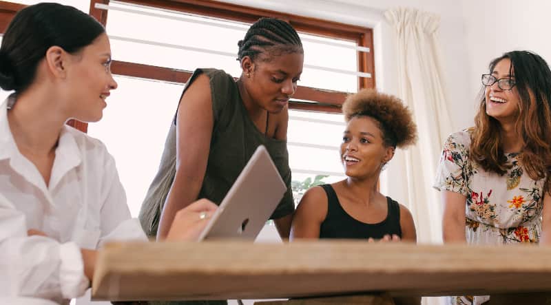 Women deeply engaged in conversation, highlighting the intimacy and support found in various types of group therapy.