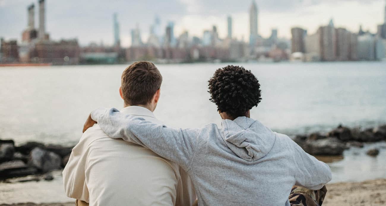 Friends overlook a cityscape, symbolizing the supportive community in contrast to psychedelics for addiction treatment.
