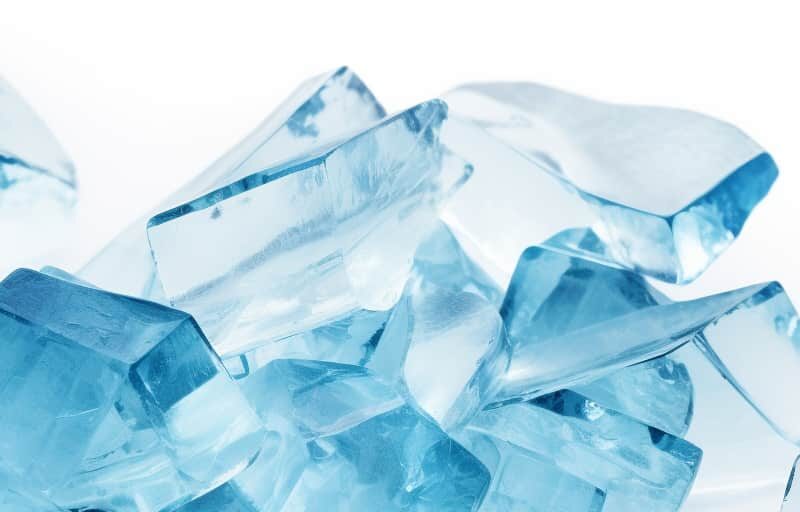 Shards of blue crystals resembling methamphetamine, symbolizing the appearance and allure of the Tina drug.