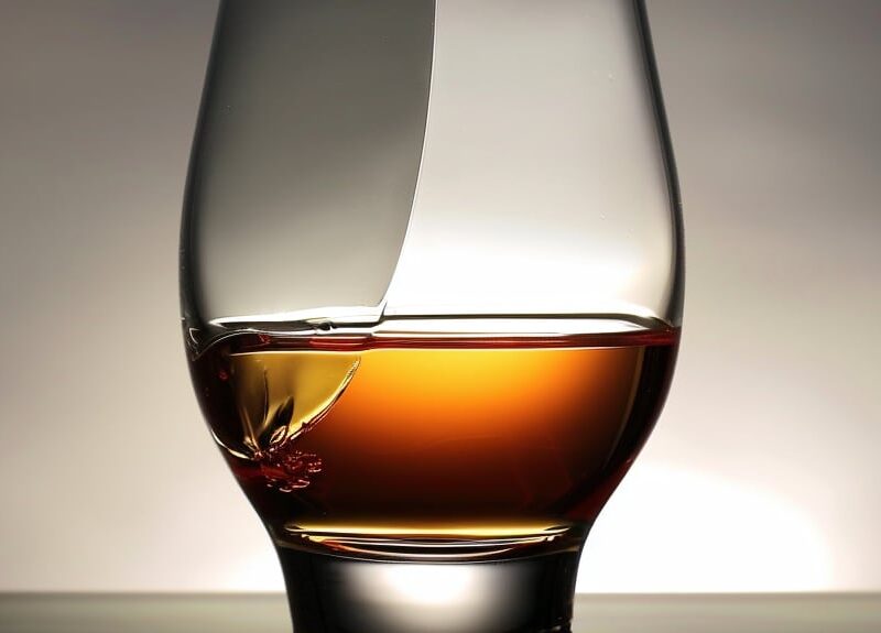 A whisky glass with a visible crack running down its side, symbolizing the fragile nature of alcohol tolerance and the potential consequences of excessive drinking.