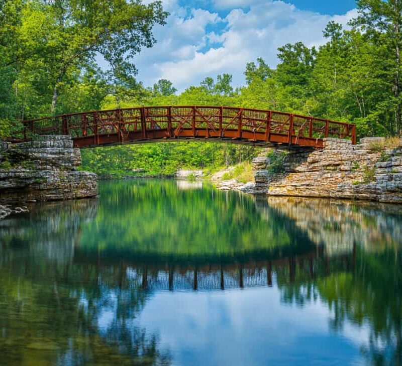 Bridge over a gentle river to show the help available in addiction treatment in Fayetteville Arkansas