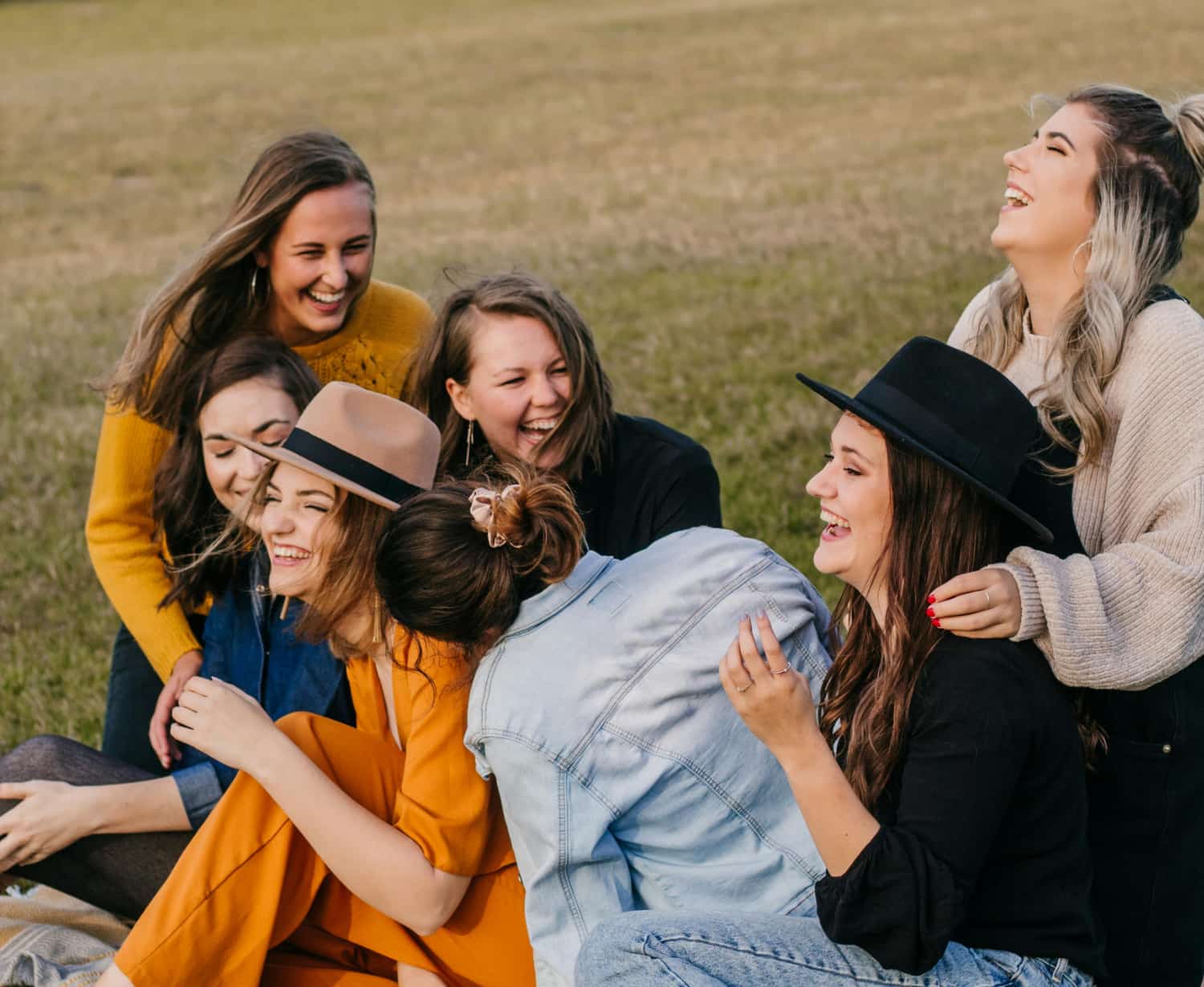 Group of young women on a grassy field showing support when my daughter is addicted.