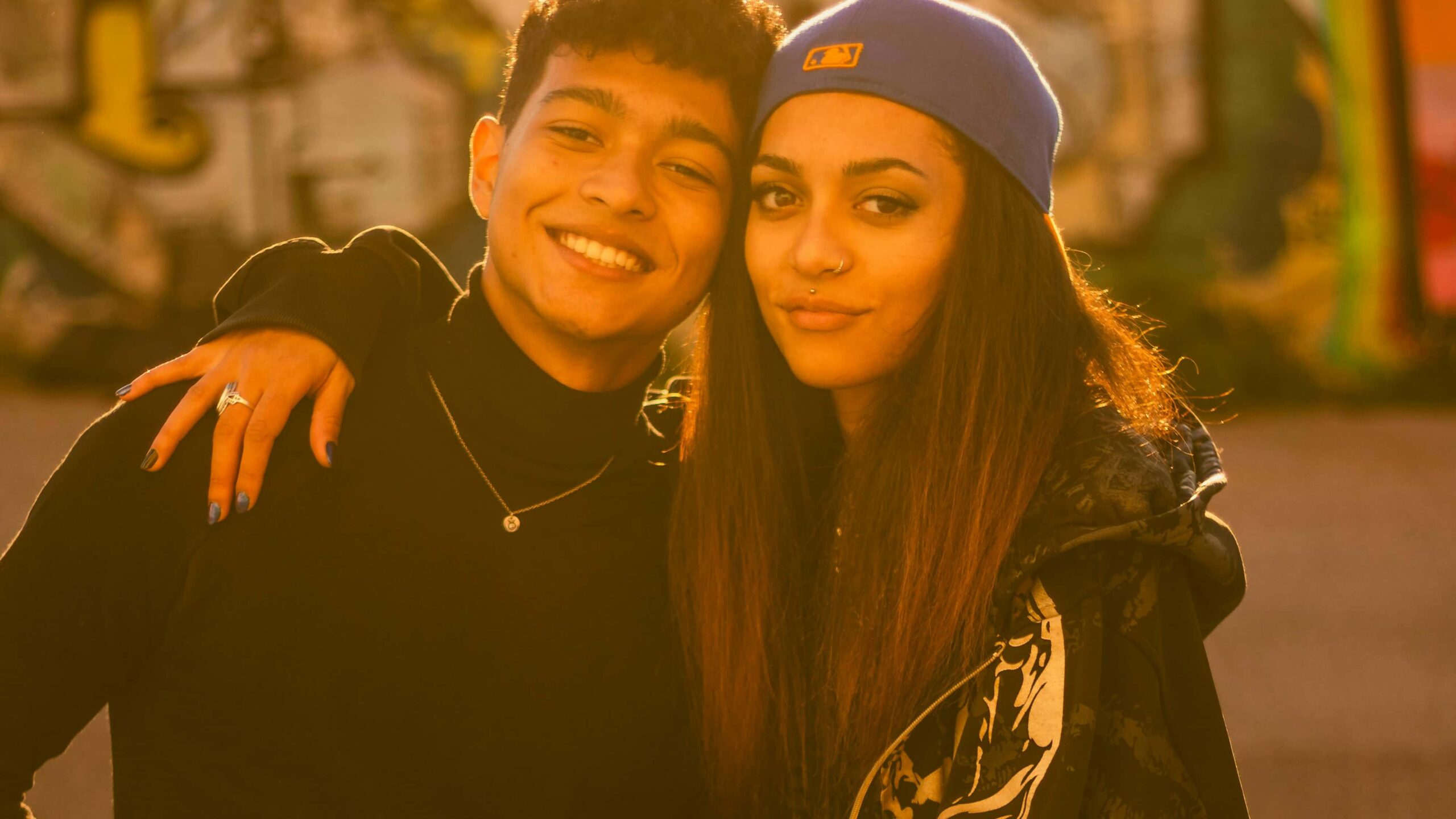 Sister and brother stand in a park in LA supporting someone in rehab