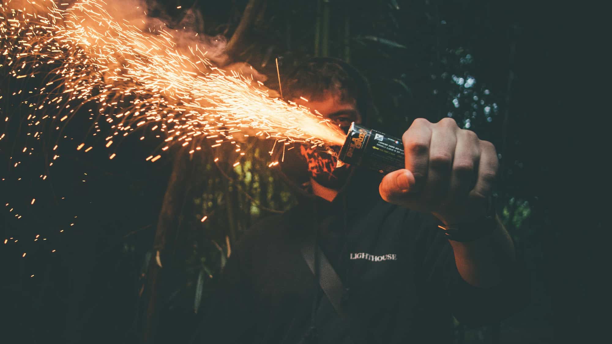 A man holds a flare close to his face showing the power of dopamine addiction in his life.