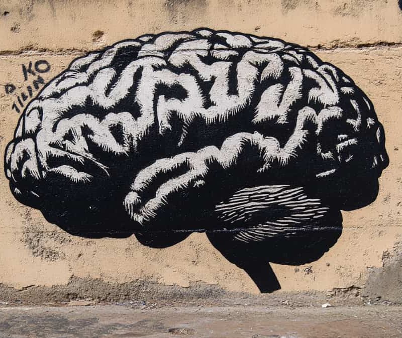 Graffiti image of a brain on a street wall, illustrating that against many misconceptions, we see drug addiction as a clinical diagnosis.